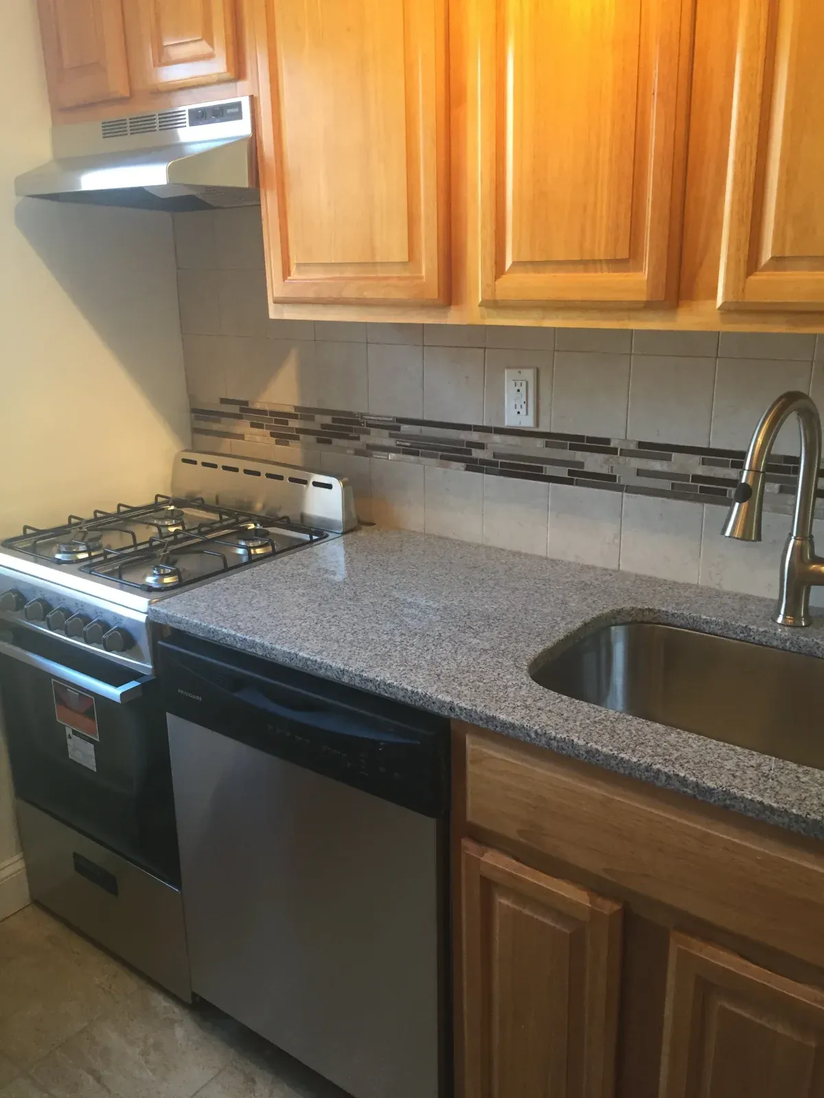 One bedroom in Whitestone, kitchen with wood cabinets, gas range and dishwasher