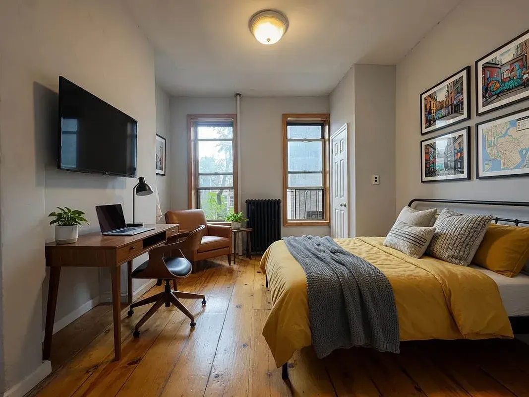 One bedroom at 13 Saint Marks Place, bedroom with desk and two windows