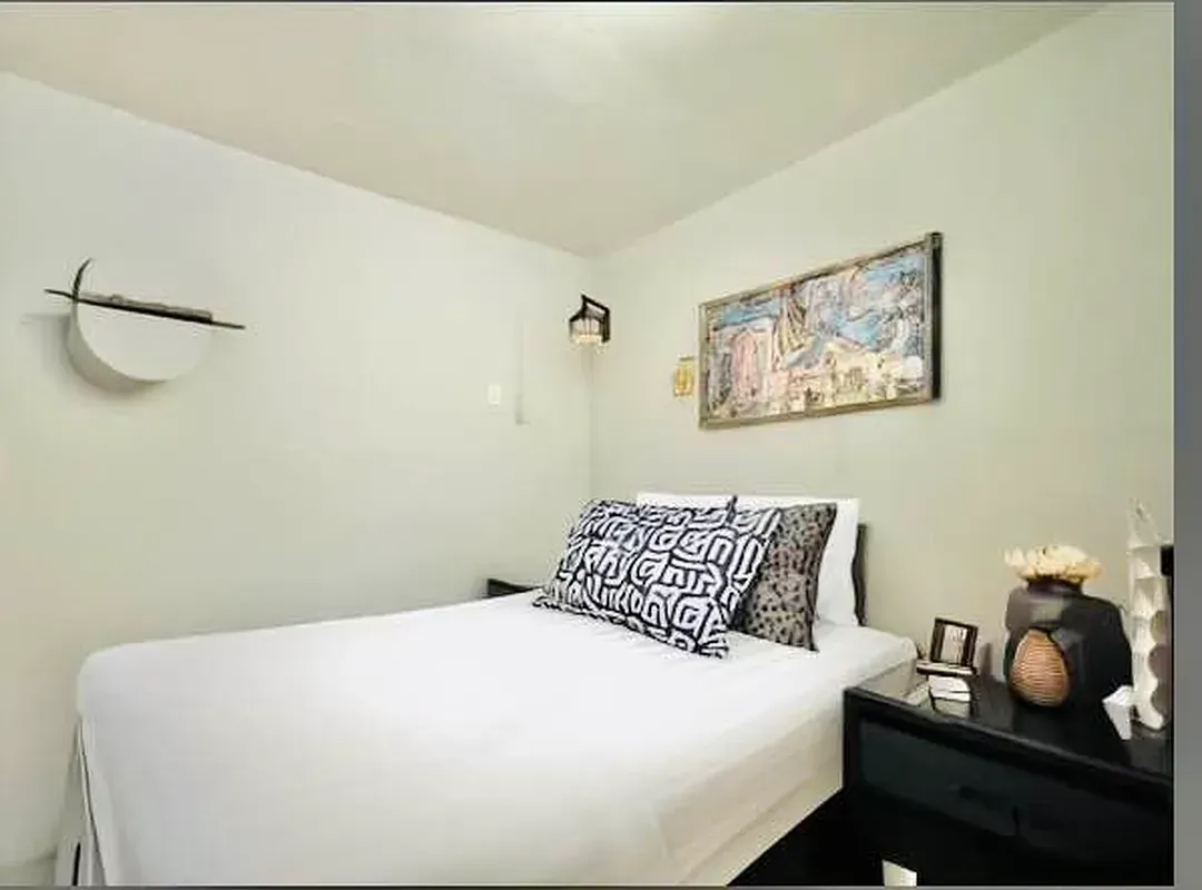 One bedroom at 520 East 6th Street, bedroom with nightstand and wall sconce