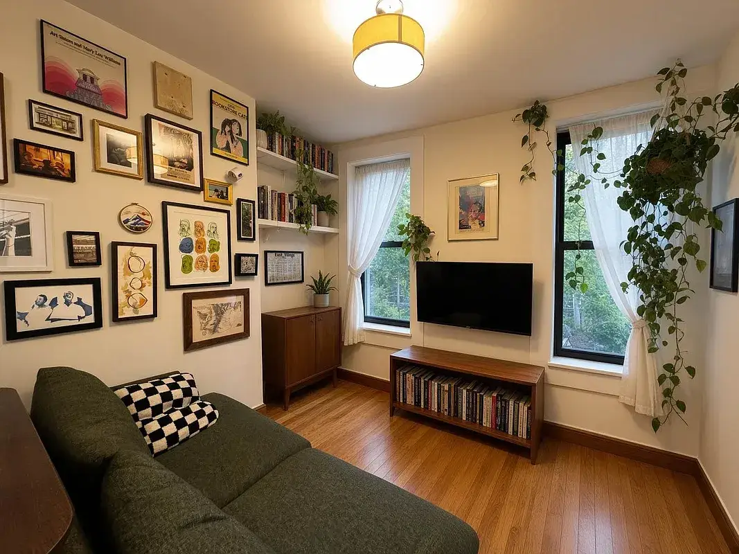 One bedroom at 518 East 6th Street, living room with green sofa and window