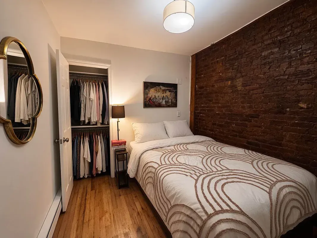 One bedroom at 518 East 6th Street, bedroom with exposed brick and closet