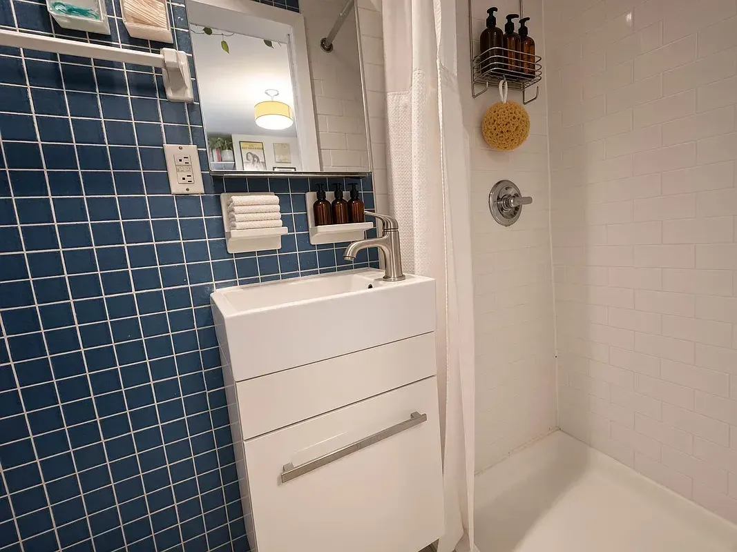 One bedroom at 518 East 6th Street, bathroom with blue tile and shower