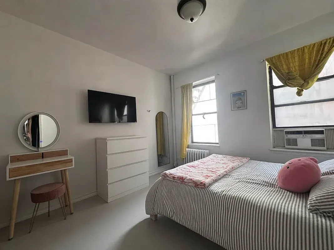 Two bedroom at 17 Saint Marks Place, bedroom with dresser and window