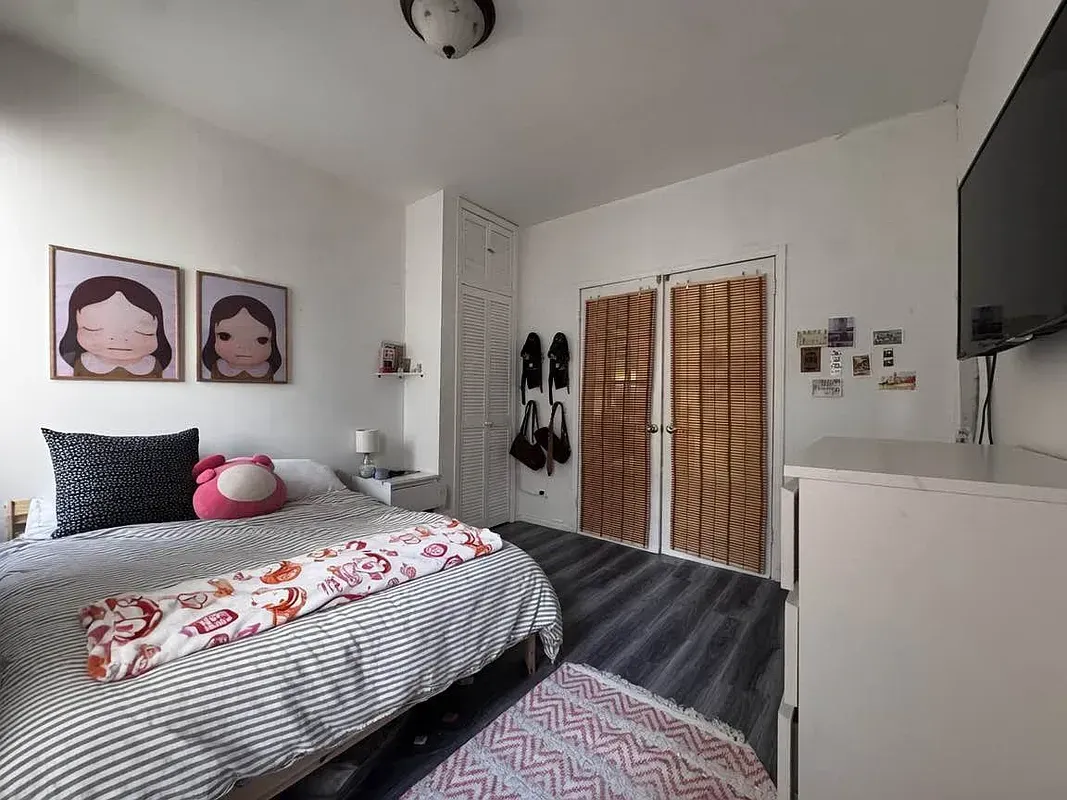 Two bedroom at 17 Saint Marks Place, bedroom with closets and wall-mounted TV