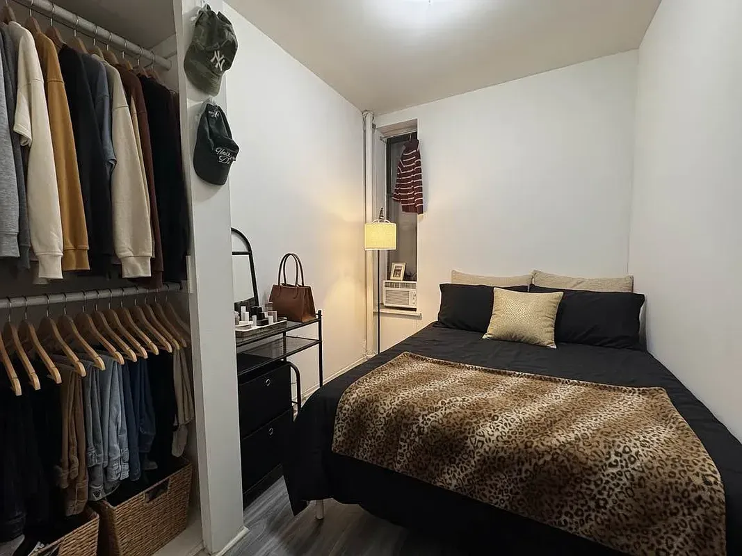 Two bedroom at 17 Saint Marks Place, bedroom with clothing rack