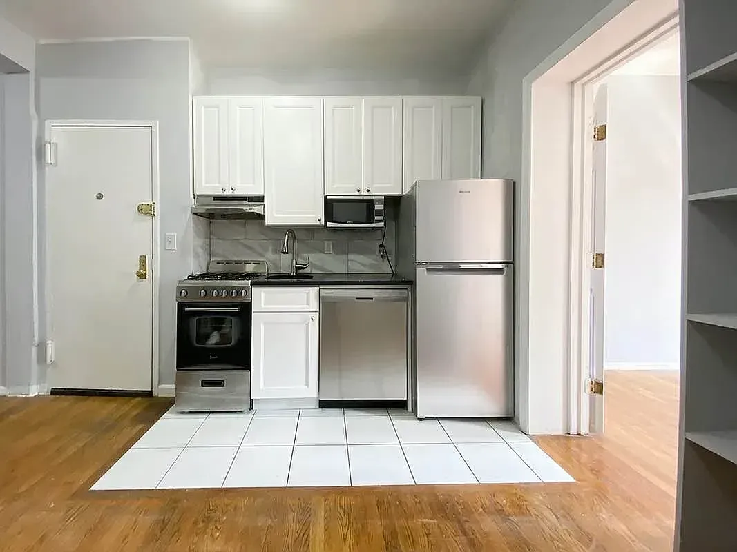 Two bedroom at 17 Saint Marks Place, kitchen with stainless refrigerator and gas range