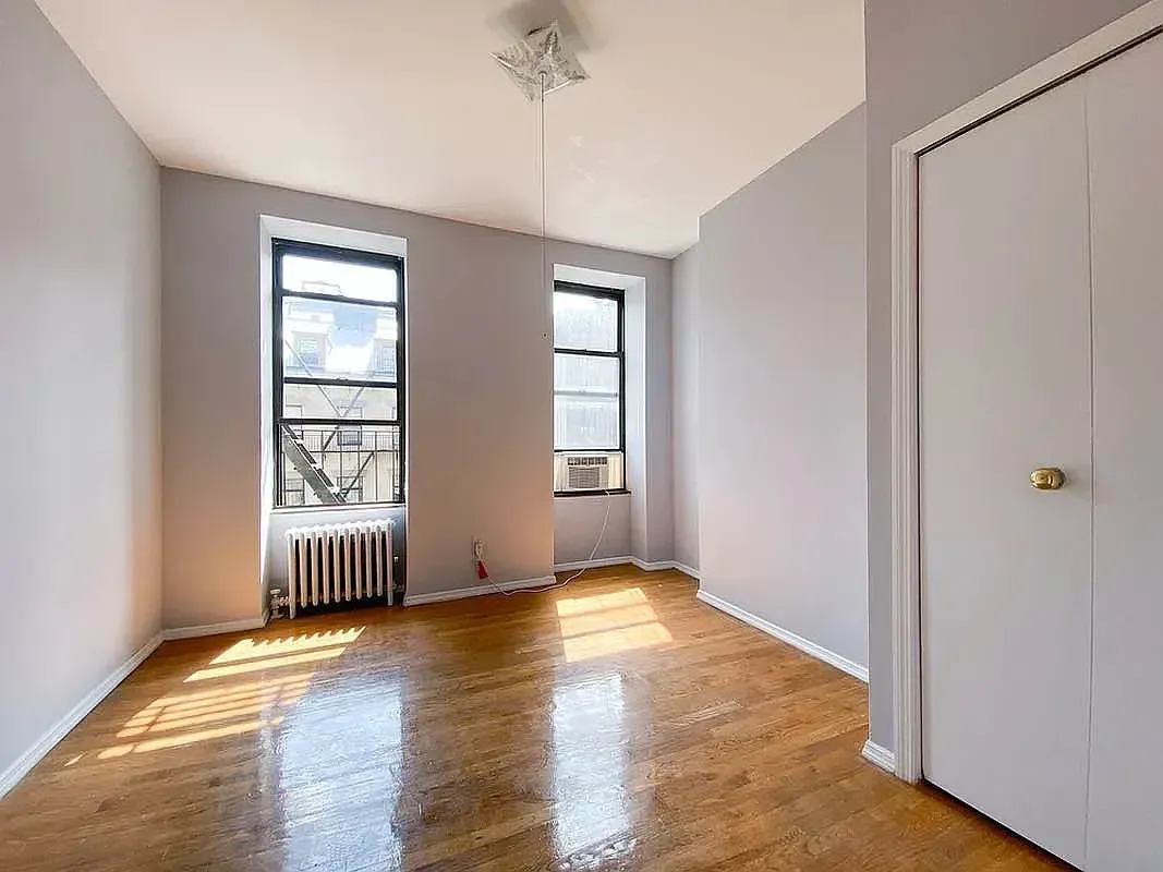 Two bedroom at 17 Saint Marks Place, empty bedroom with two windows and closet