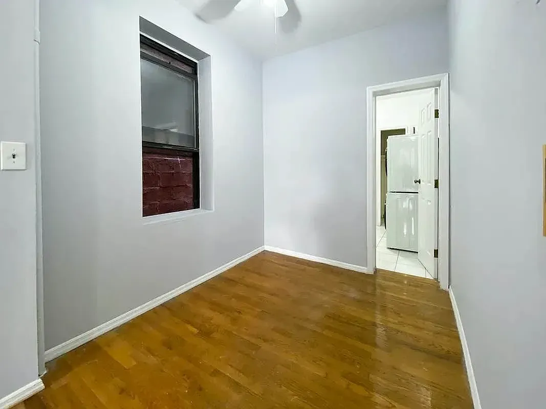 Two bedroom at 17 Saint Marks Place, empty bedroom with window and hardwood floors