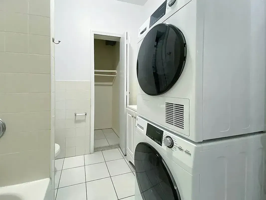 Two bedroom at 17 Saint Marks Place, bathroom with stacked washer and dryer