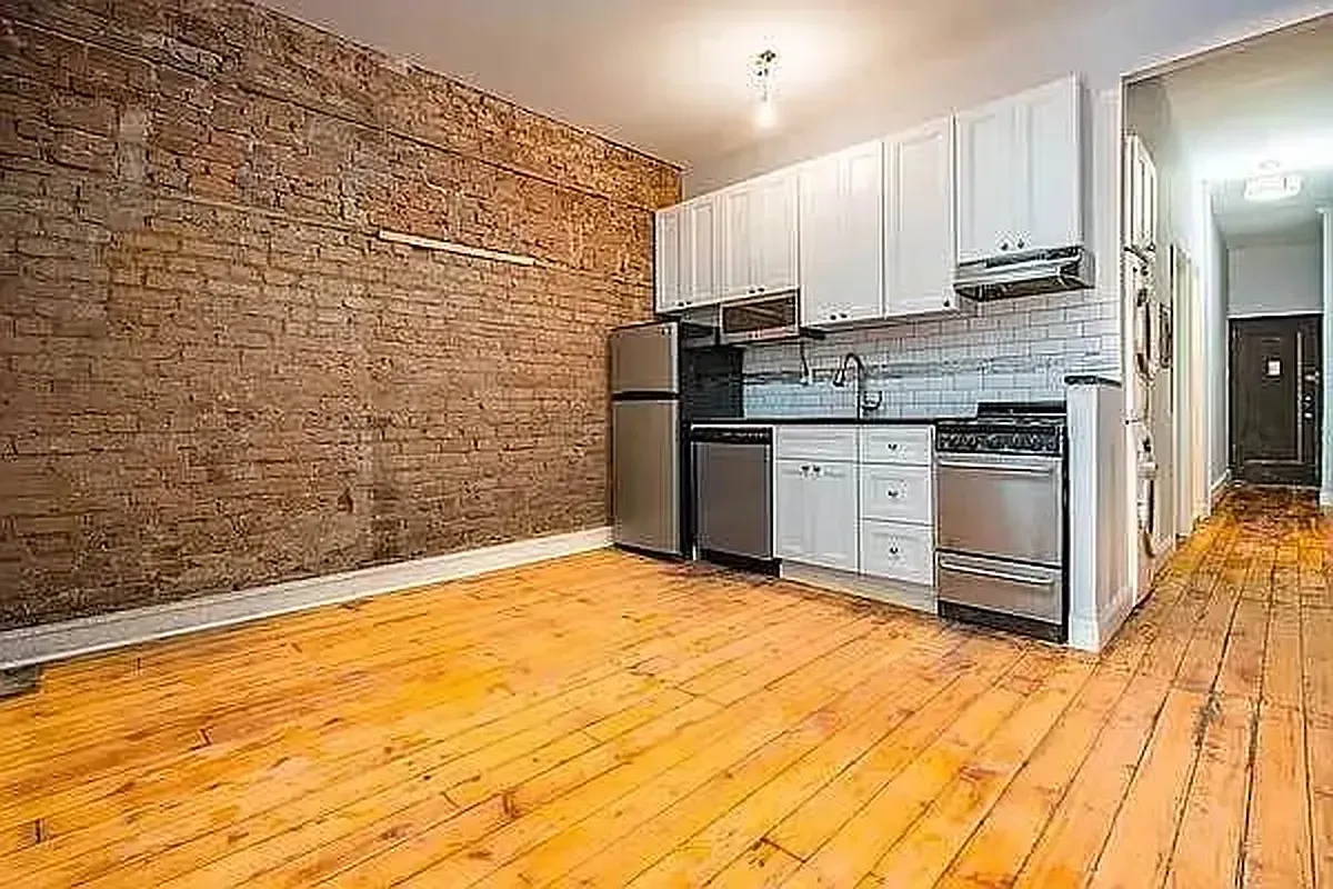 Three bedroom at 13 Saint Marks Place, kitchen with exposed brick and hardwood floors