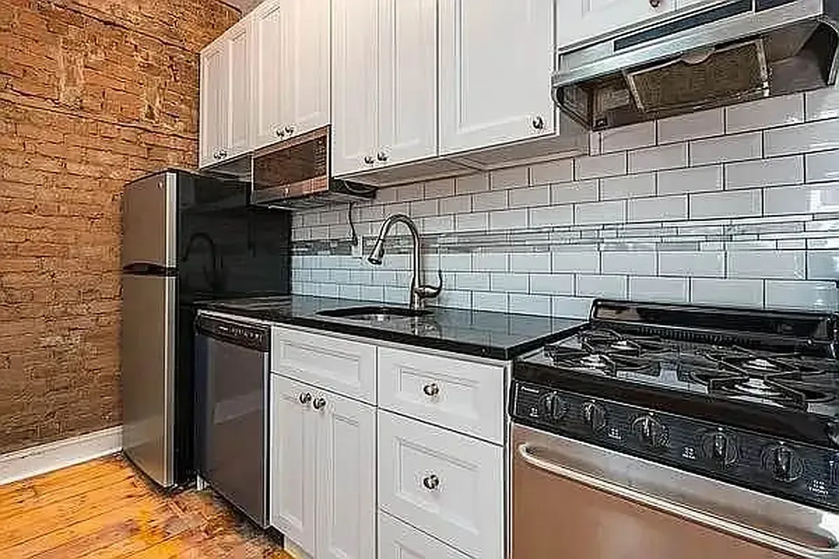Three bedroom at 13 Saint Marks Place, kitchen with subway tile and stainless range