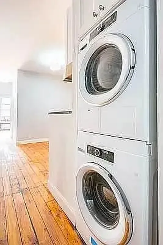 Three bedroom at 13 Saint Marks Place, stacked washer and dryer in the hallway