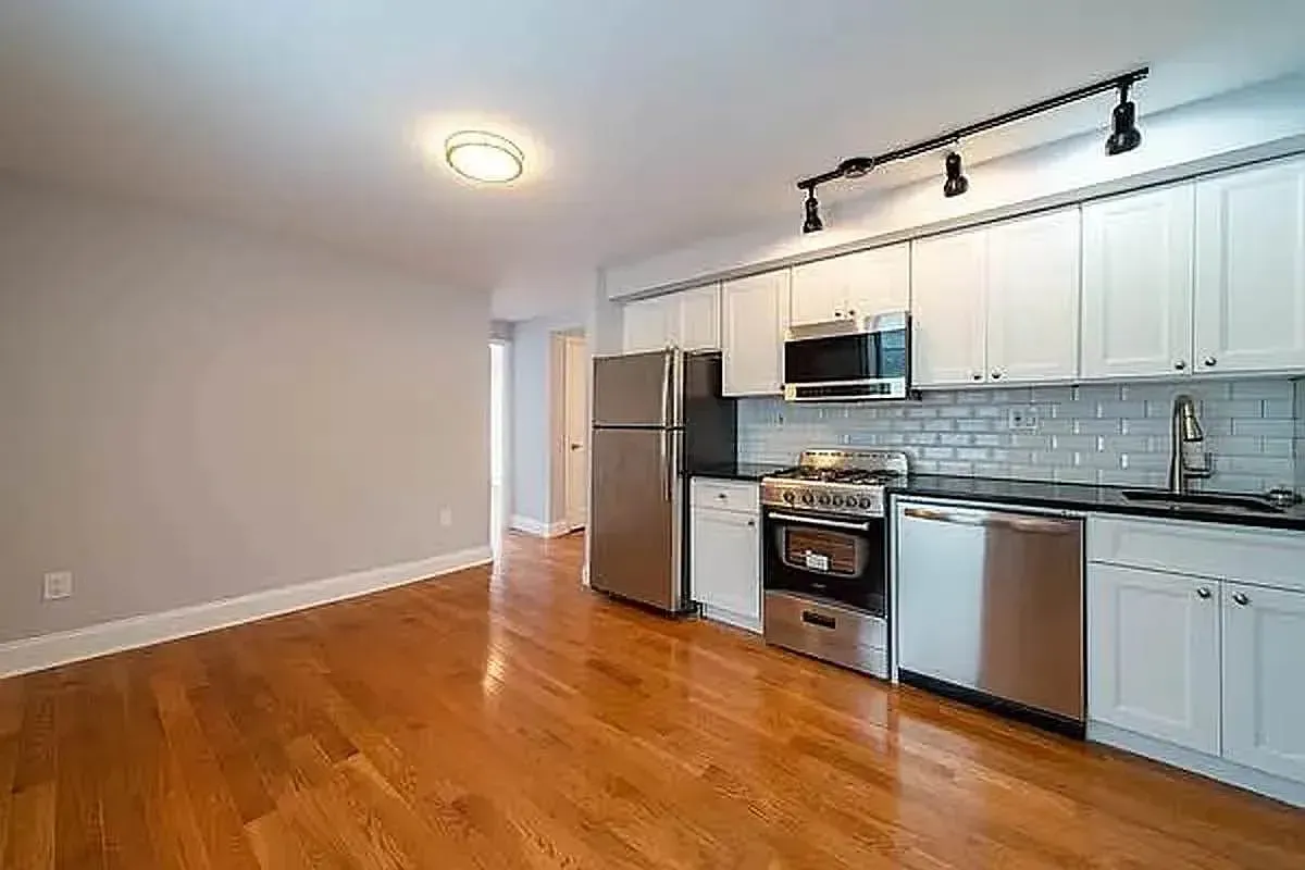 Three bedroom at 93 Avenue B, kitchen with white cabinets and subway tile