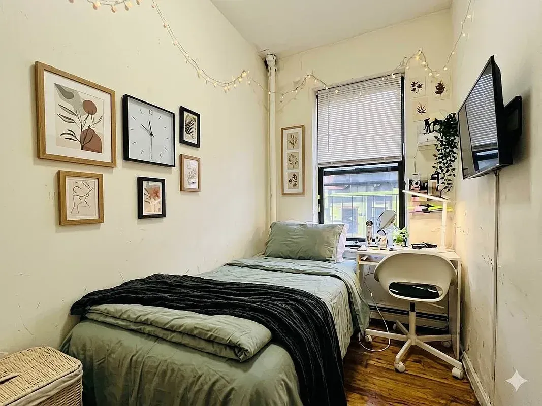 Three bedroom at 17 Saint Marks Place, bedroom with framed prints and window