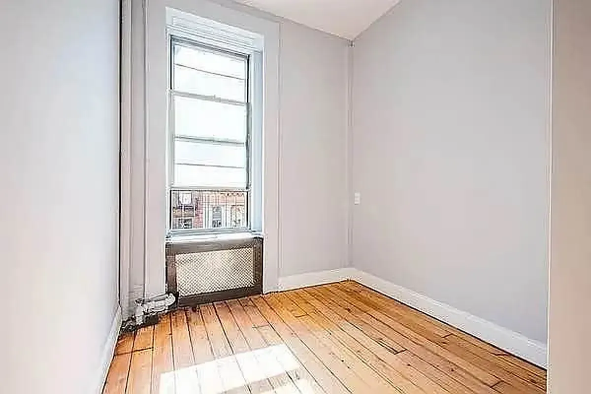 Three bedroom at 13 Saint Marks Place, empty bedroom with window and radiator