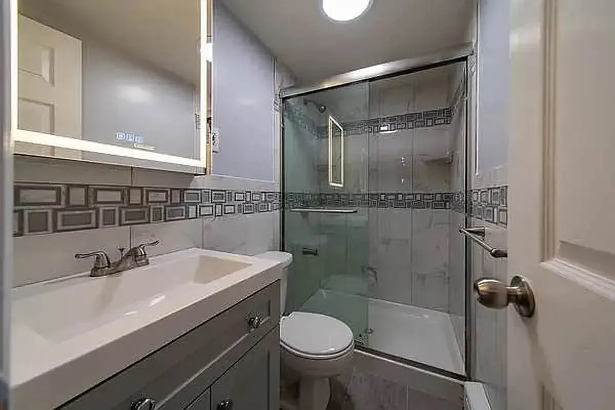 Three bedroom at 93 Avenue B, bathroom with glass shower and vanity