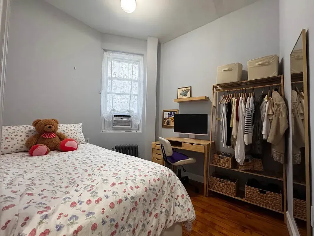 Three bedroom at 34½ Saint Marks Place, bedroom with desk and clothing rack