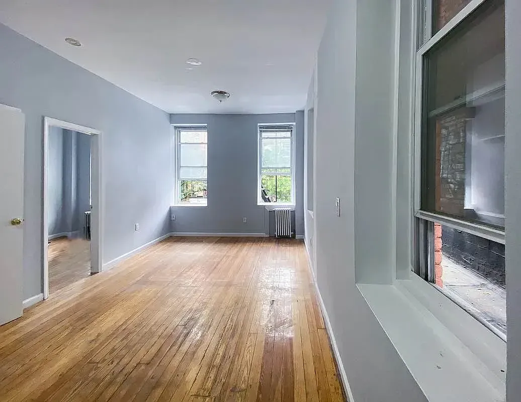 Three bedroom at 34½ Saint Marks Place, empty living room with two windows