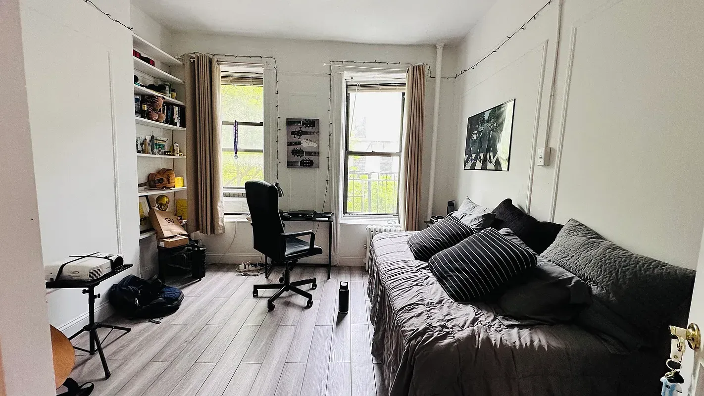 Three bedroom at 17 Saint Marks Place, living room with desk and two windows