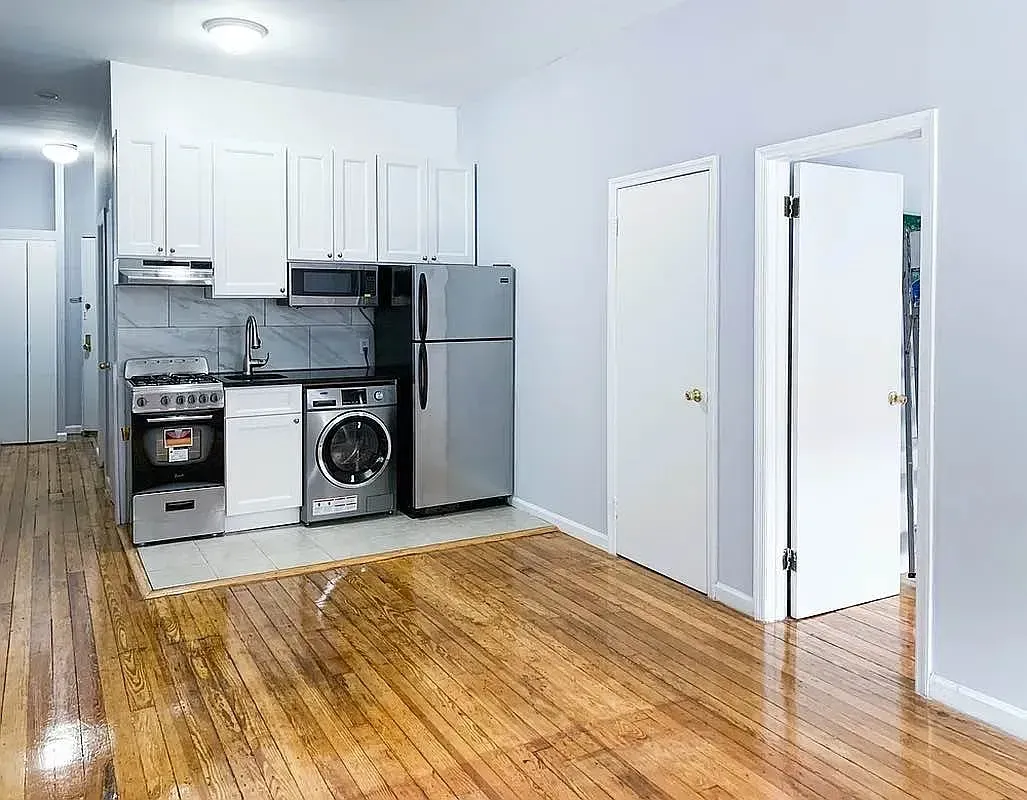 Three bedroom at 34½ Saint Marks Place, kitchen with white cabinets and washing machine