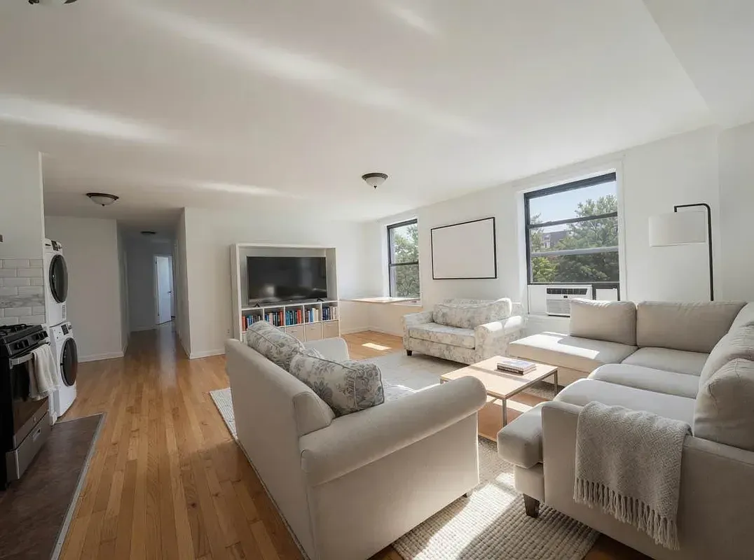 Four bedroom at 93 Avenue B, living room with sectional sofa and two windows