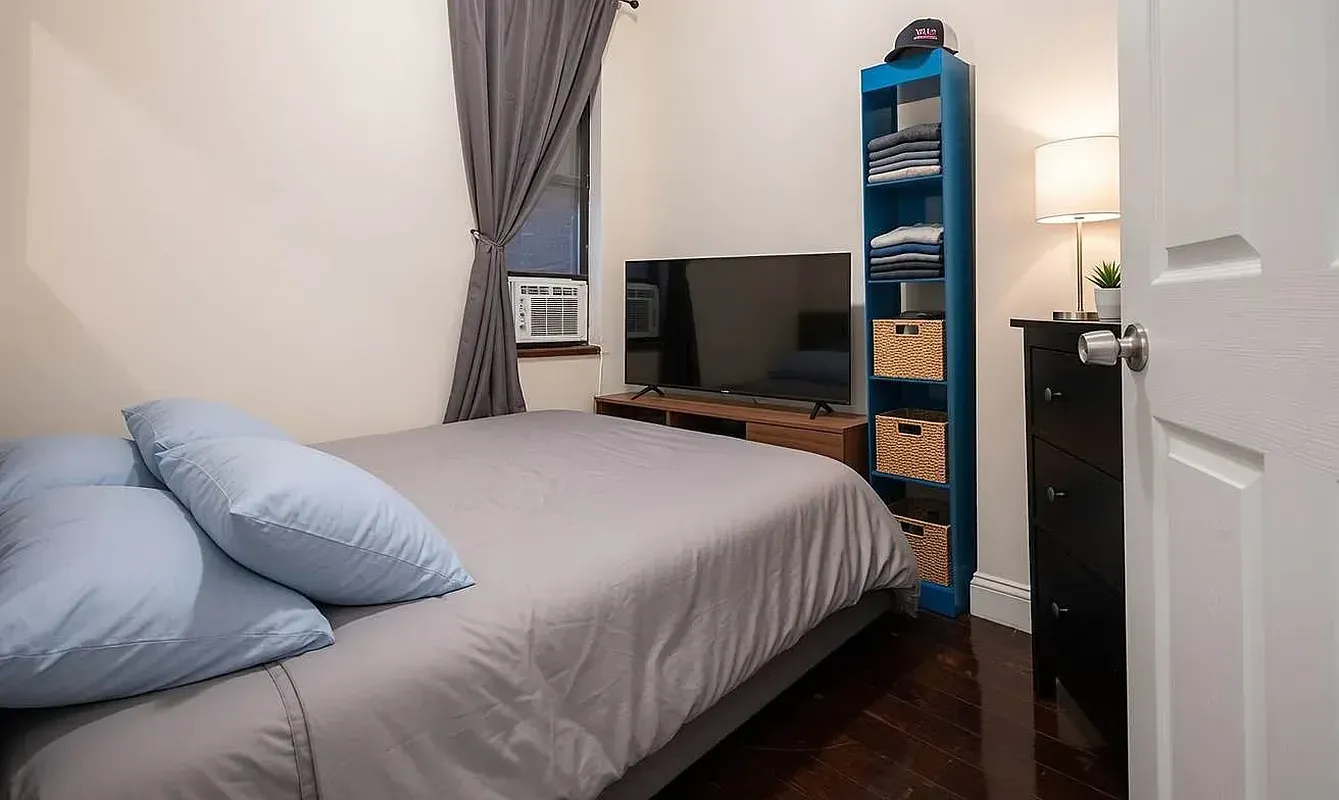 Four bedroom at 13 Saint Marks Place, bedroom with bed and bookshelf