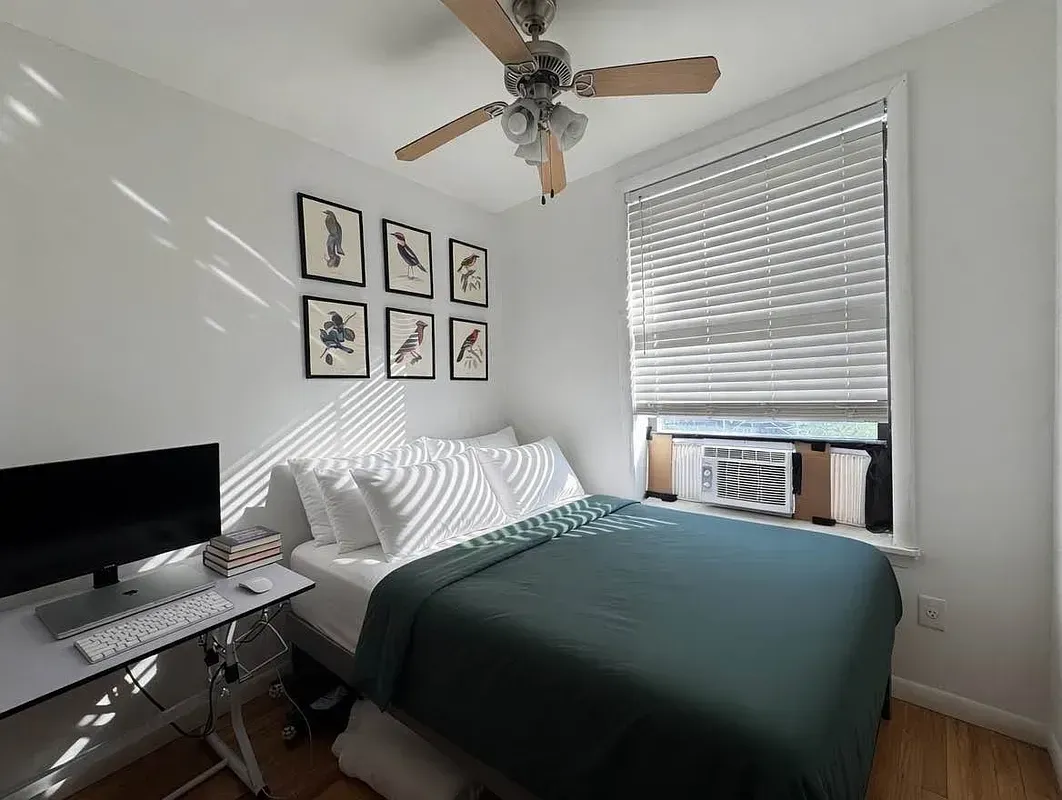 Four bedroom at 93 Avenue B, bedroom with desk and ceiling fan