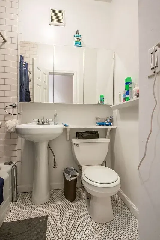 Four bedroom at 13 Saint Marks Place, bathroom with pedestal sink and mirror