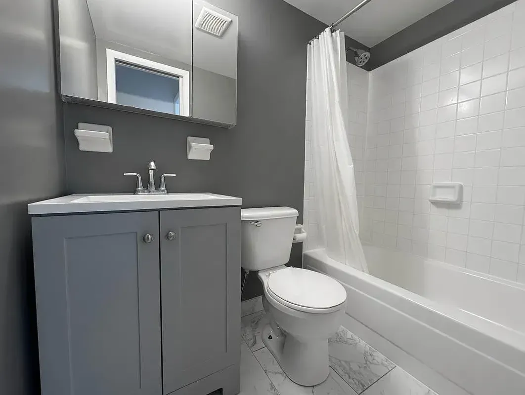 Four bedroom at 93 Avenue B, bathroom with tub and vanity