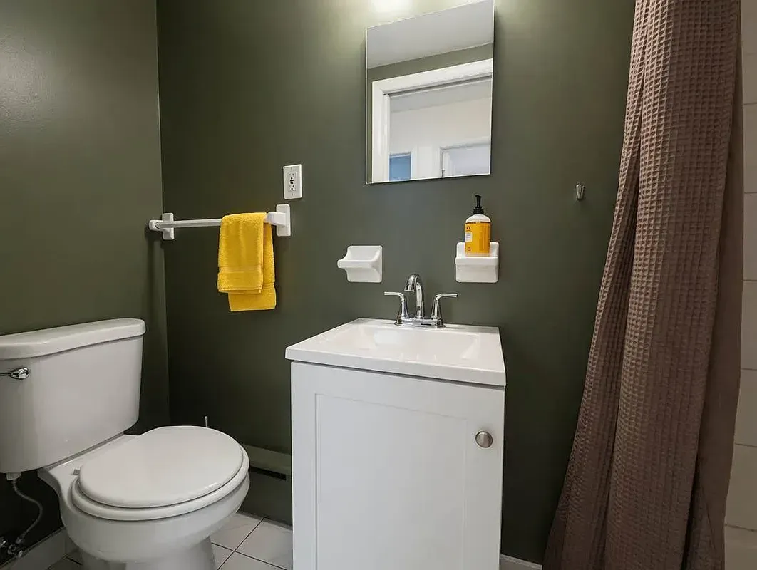 Four bedroom at 93 Avenue B, bathroom with green walls and window