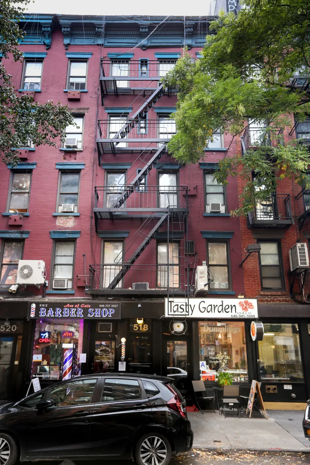 518 East 6th Street, a walk-up with a fire escape and shops below