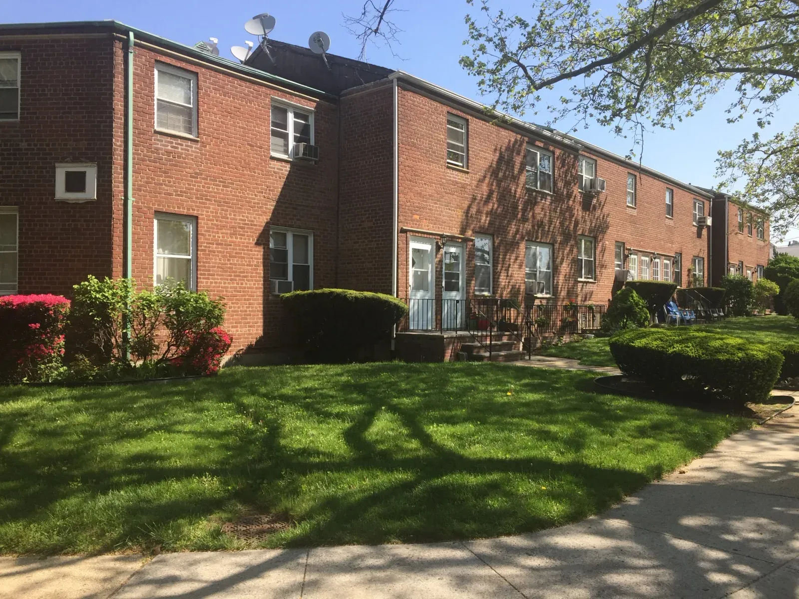 Whitestone, brick garden apartments with a lawn