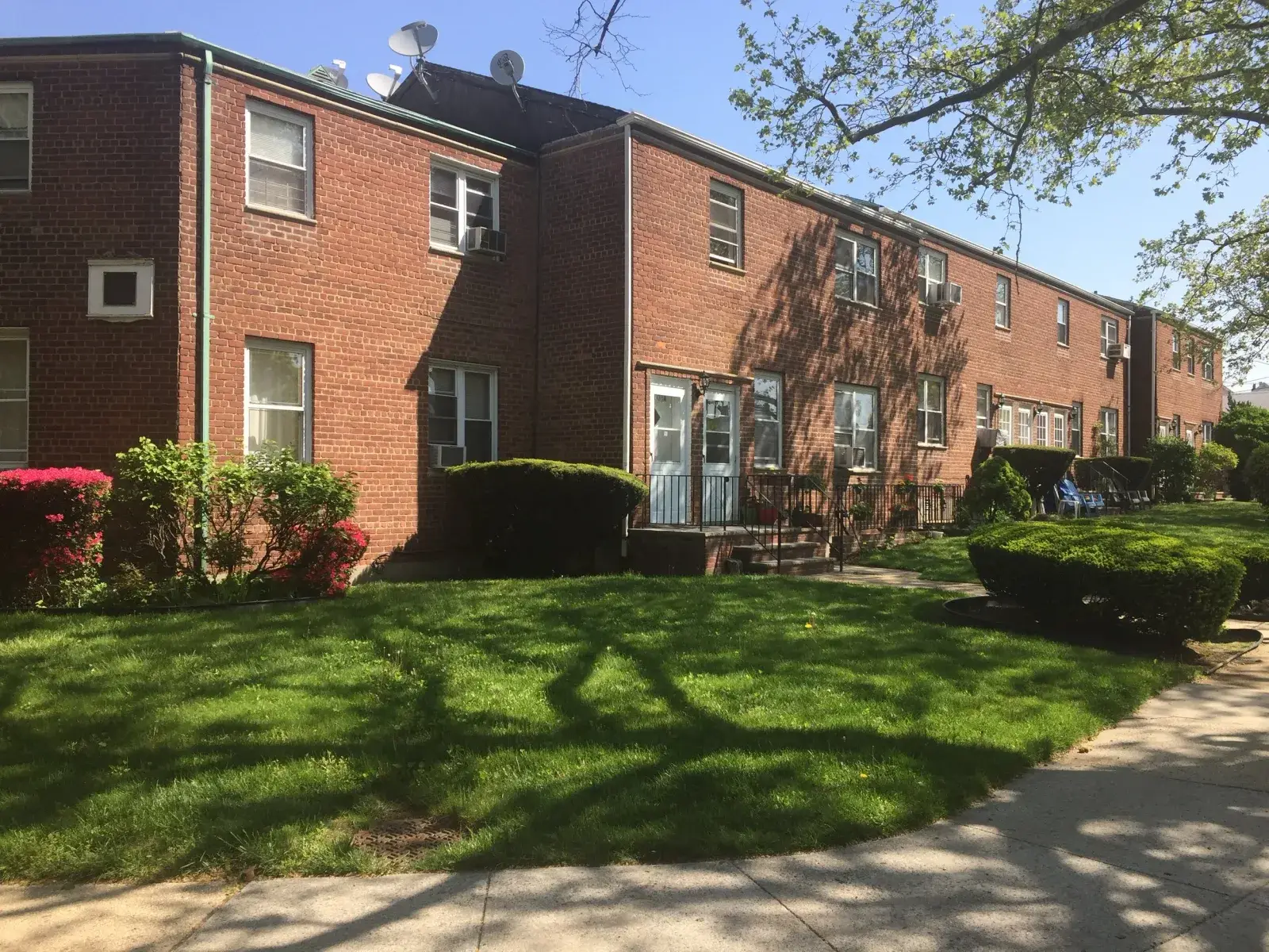 Whitestone, brick garden apartments with a lawn