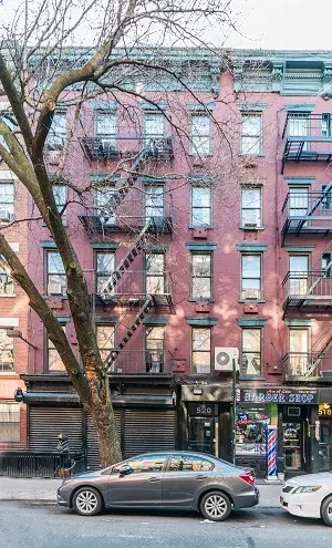 520 East 6th Street, a brick walk-up behind a tree
